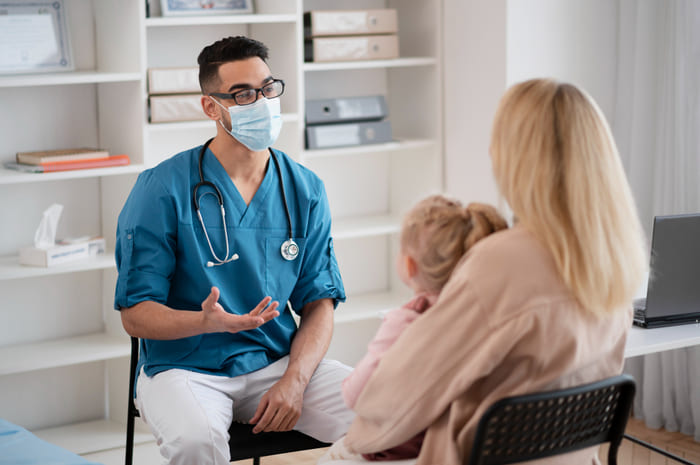 A HealthyfyX doctor consulting with a patient and their family